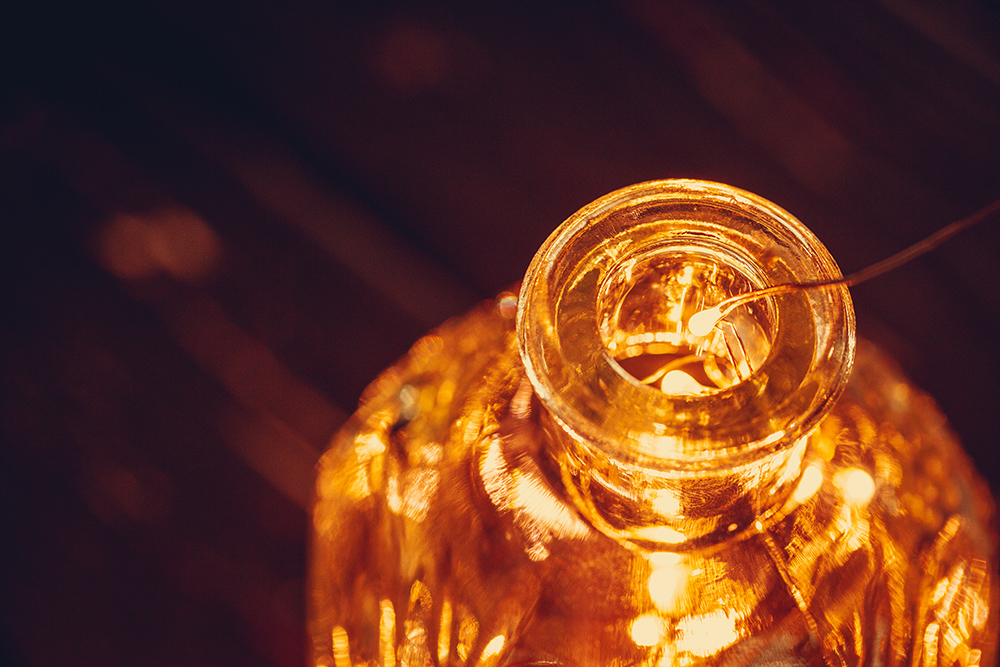Christmas lights garland put in bottle in the dark close up